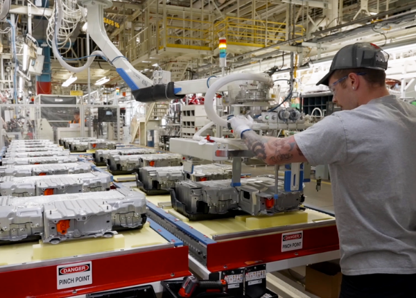 Worker at Toyota working with batteries