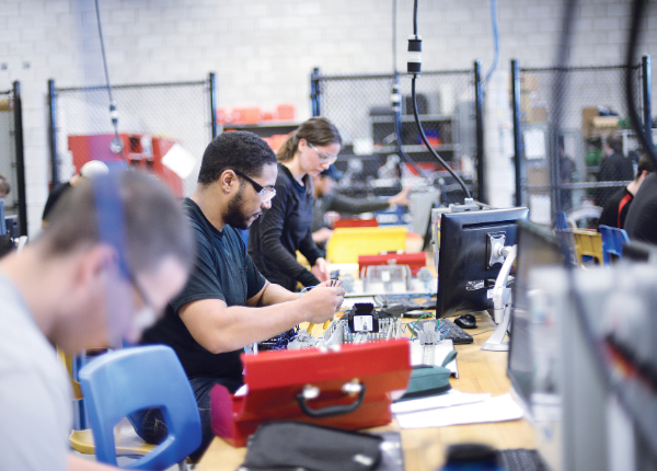 Manufacturing students working on a project