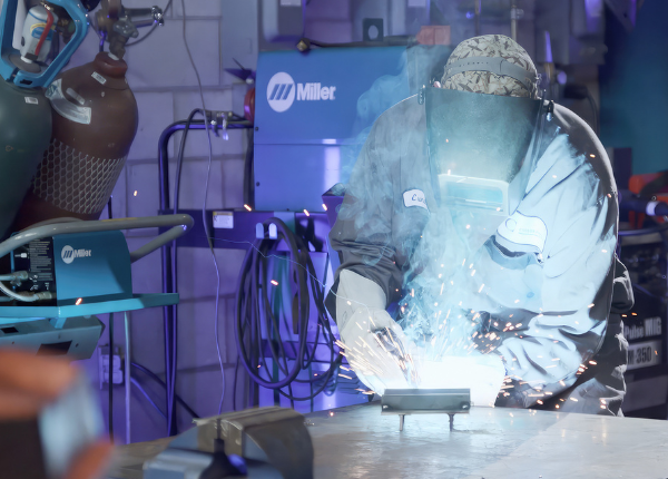 Worker welding in manufacturing facility in Waterloo Region