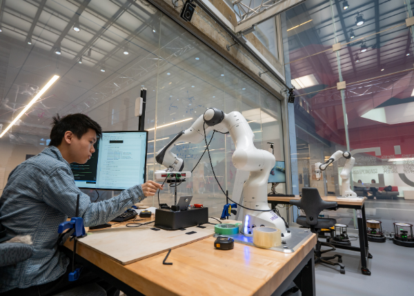 Student working with robot at RoboHub