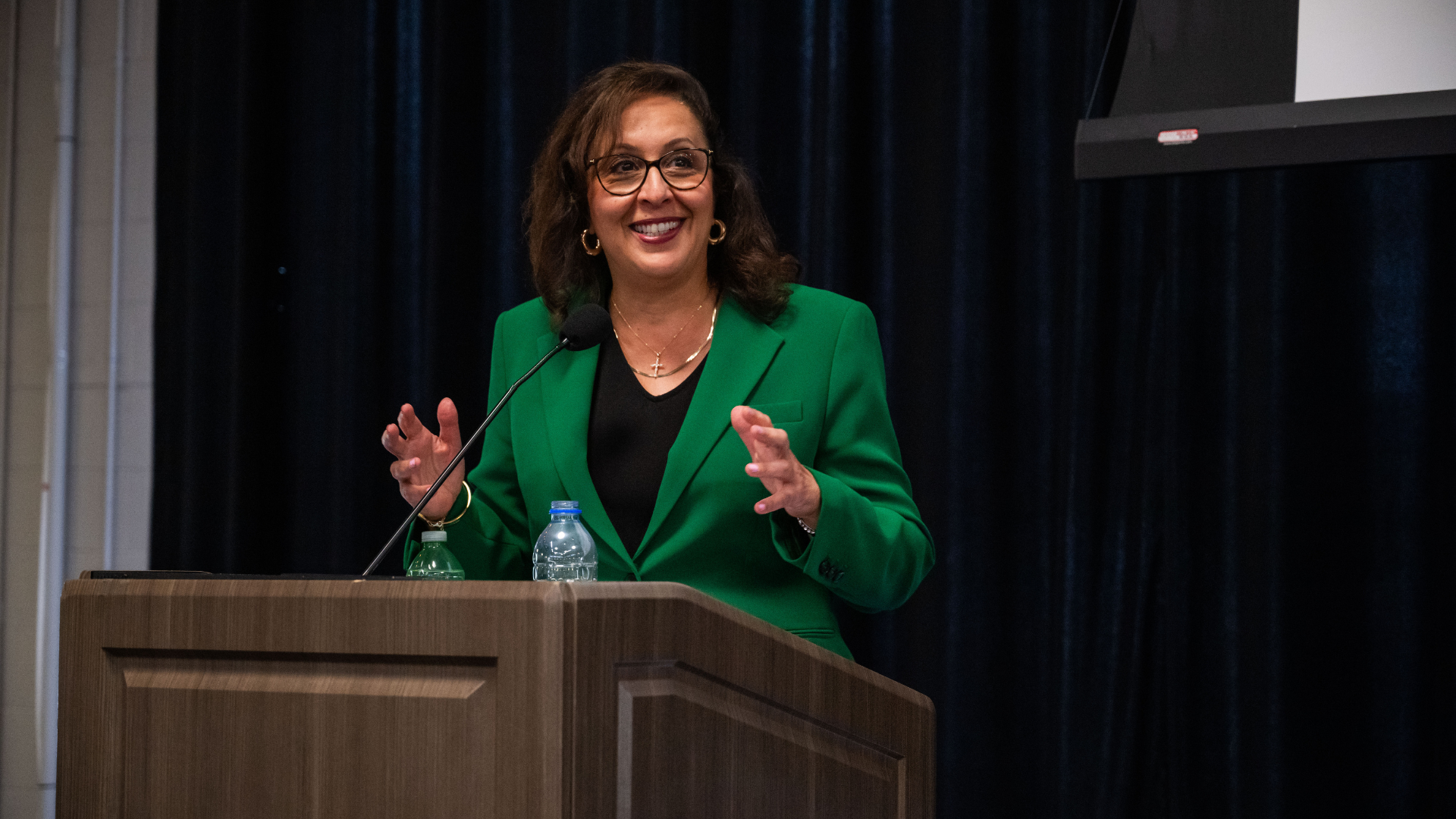 Amy Karam delivering a speech at CHARGING AHEAD