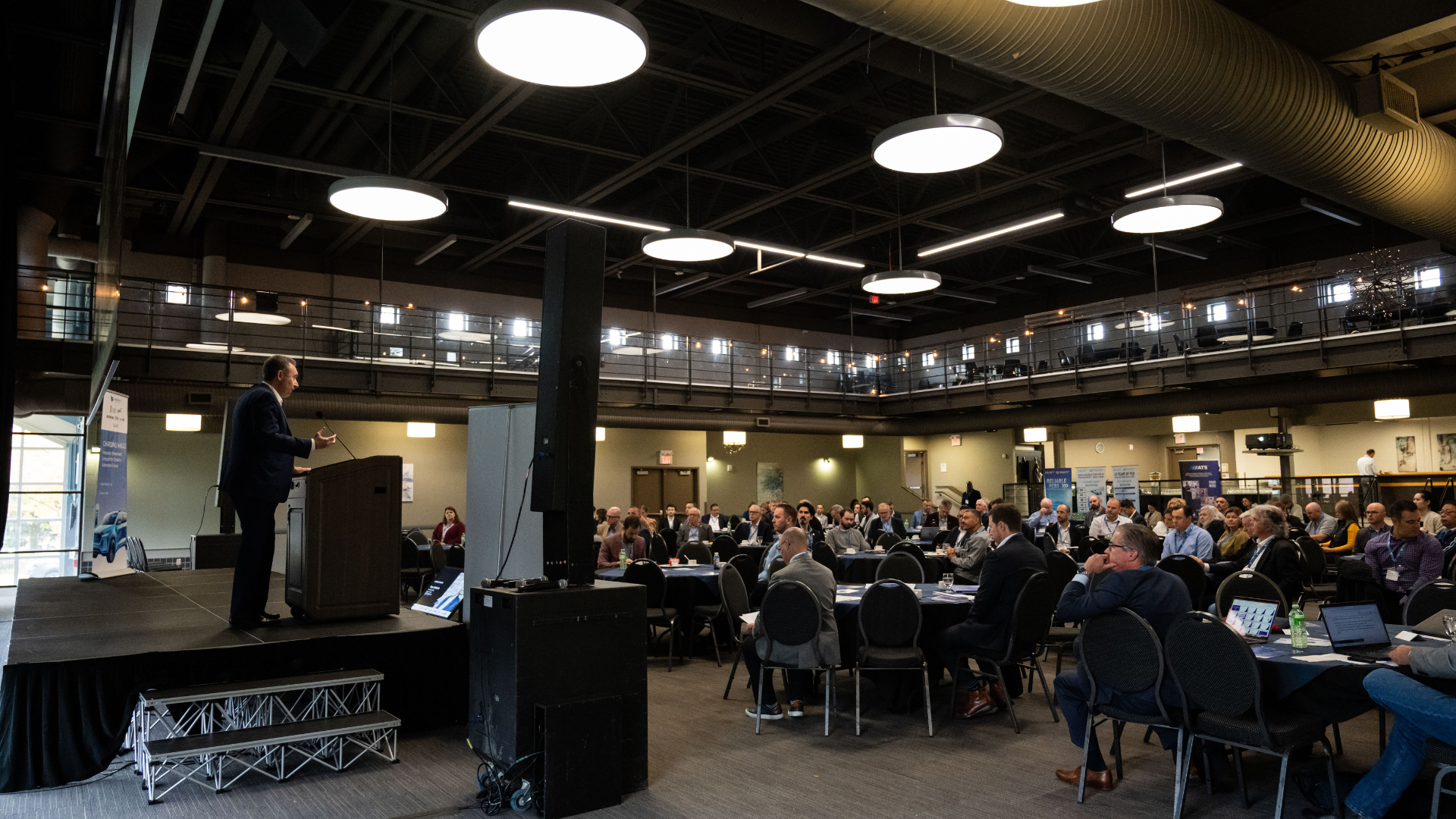Tony delivering a speech to symposium attendees.