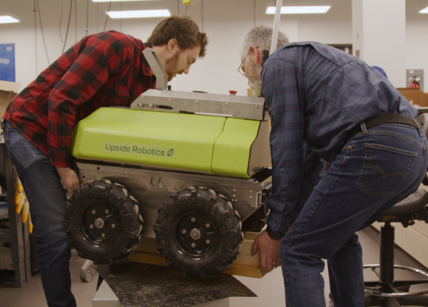 Two people working with a robot at Velocity